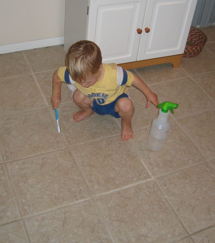 Paul cleans the floor with a toothbrush