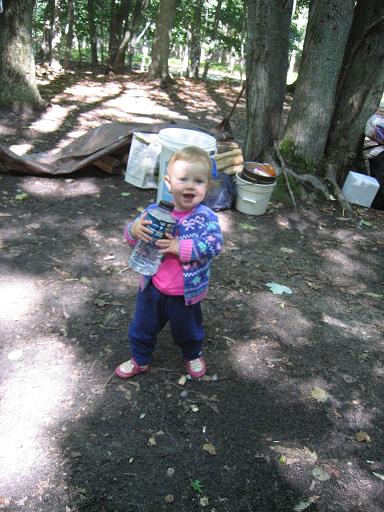 Toddler carrying a huge water bottle.