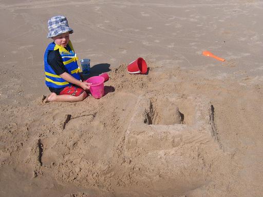 Young boy building a sand castle