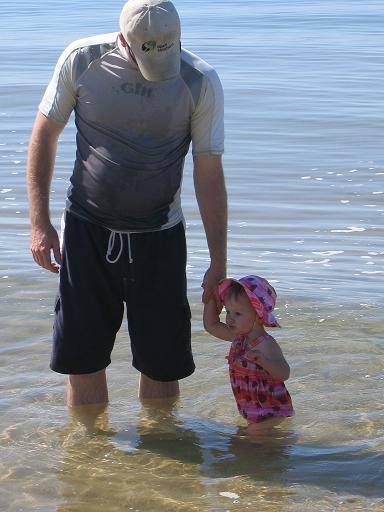 Dad and toddler girl in the lake.
