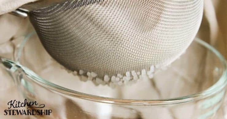 Straining yogurt through colander