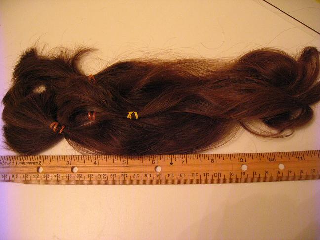 Using a rule to measure hair that has been cut
