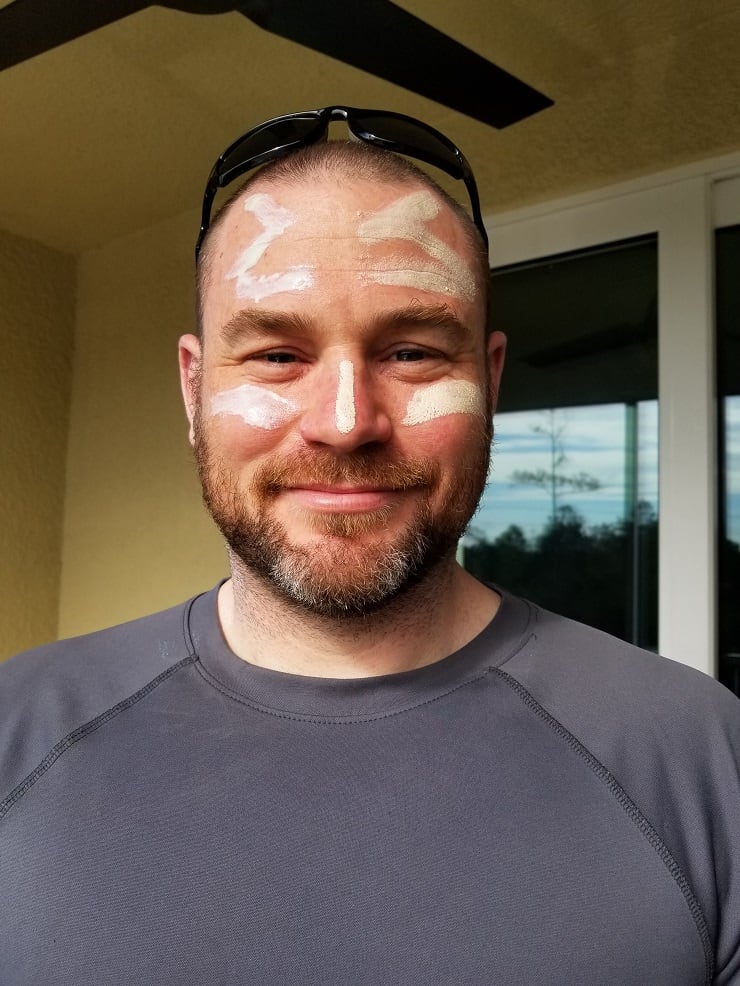 A man with sunscreen on his face looking at the camera