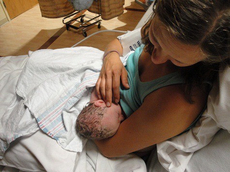 Katie Kimball nursing a newborn