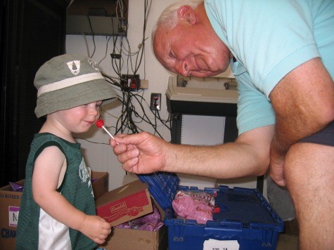 Grandparent and grandchild with red candy sucker