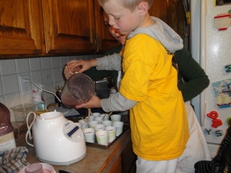 little boy using dairy-free ingredients for homemade popsicles