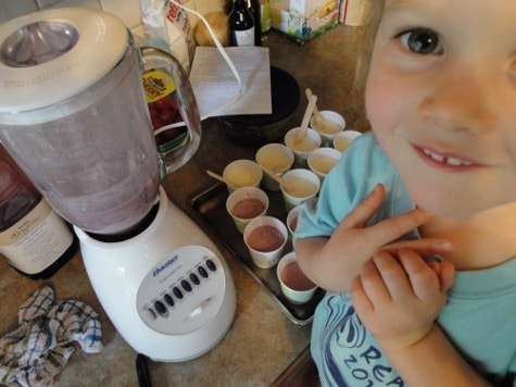 Little girl and blender making easy homemade popsicles
