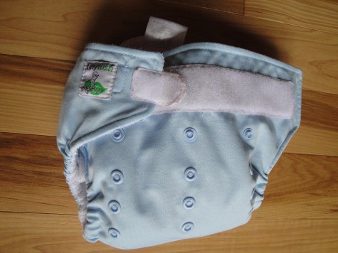 A tiny tush pocket cloth diaper on a wooden table