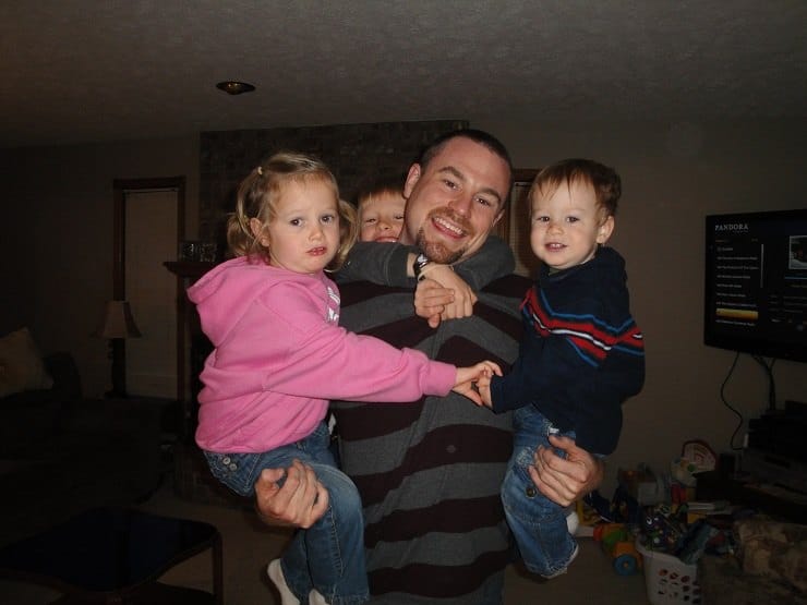 husband holding all 3 kids