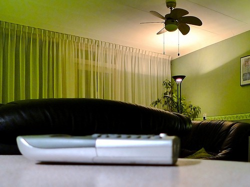 Cordless phone sitting on a table with a couch in the background