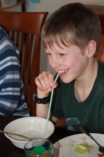 Kids eating creamy cauliflower soup with straws