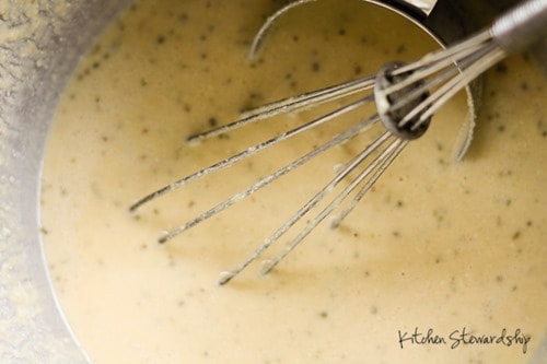 Garbanzo bean flour pizza crust batter with whisk and measuring cup