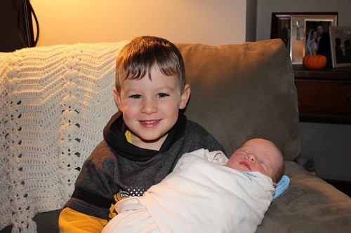 John holds baby brother