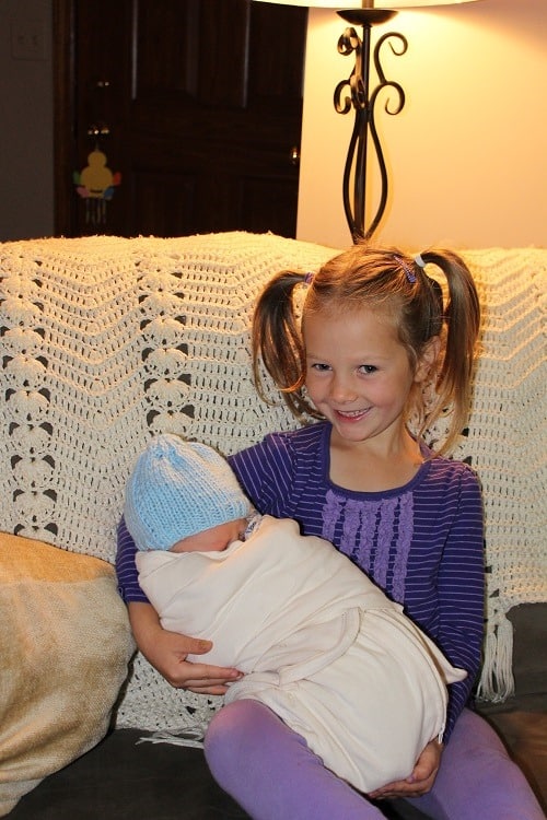 Leah overjoyed to hold baby brother