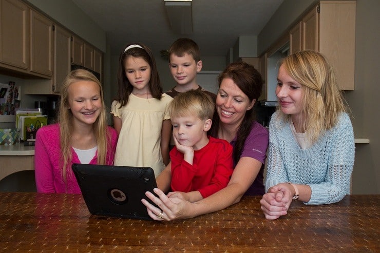 Family watches the videos from the Kids Cook Real Food eCourse
