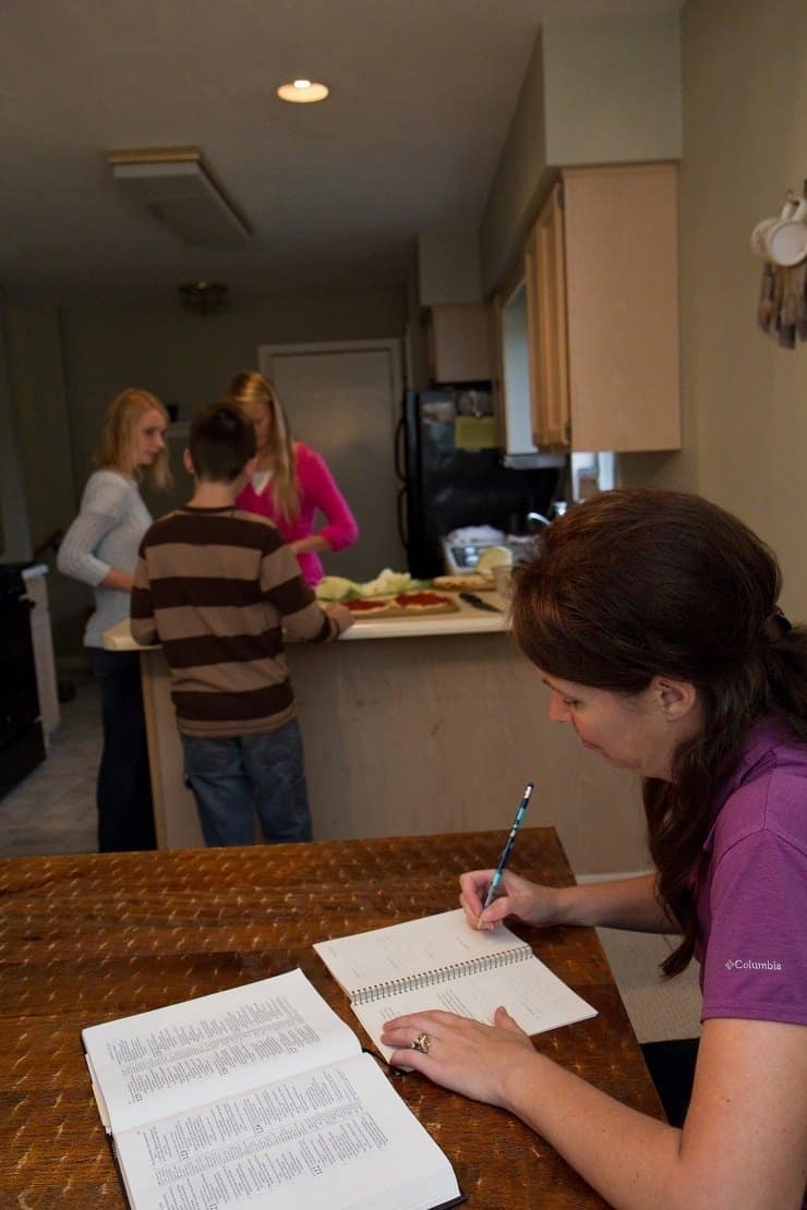 kids cooking while mom reads