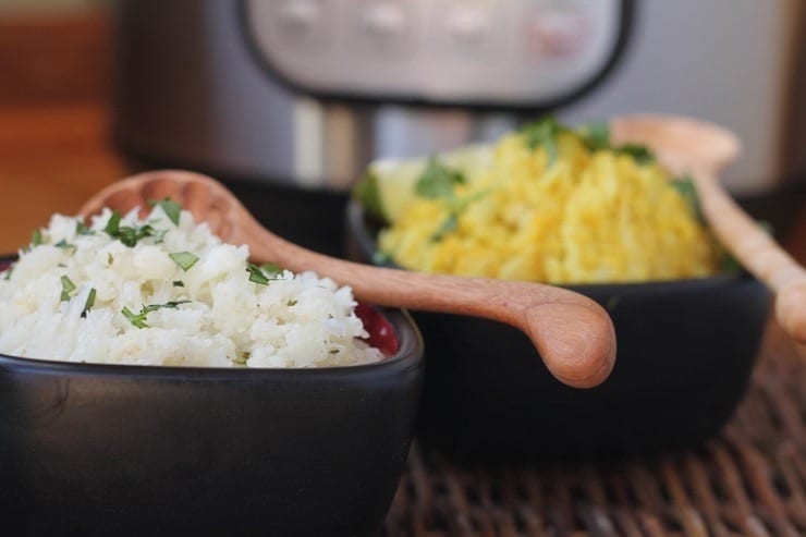 2 bowls of cauliflower rice, each with different seasonings, in front of an Instant Pot