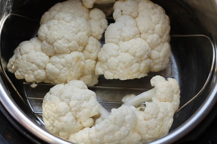 large chunks of cauliflower on steamer insert in Instant Pot
