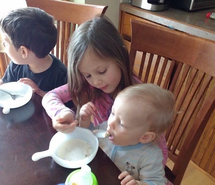 Feeding Gabe oatmeal at the table