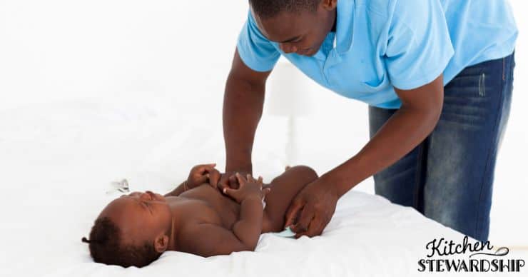 dad changing baby's diaper