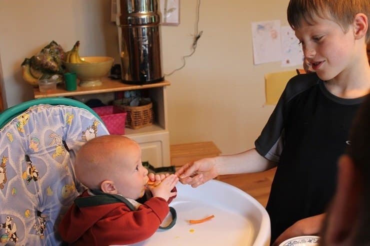 Paul feeds Gabe egg yolk