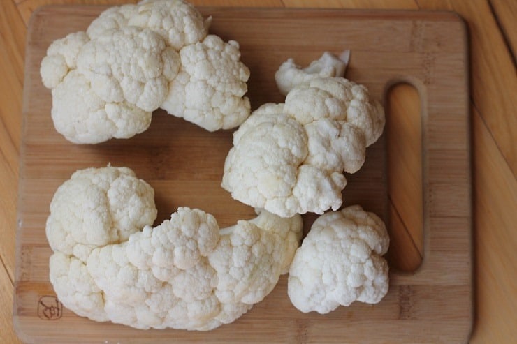 cauliflower in large chunks on a cutting board