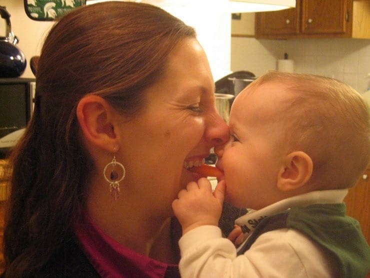 mom and baby sharing carrot