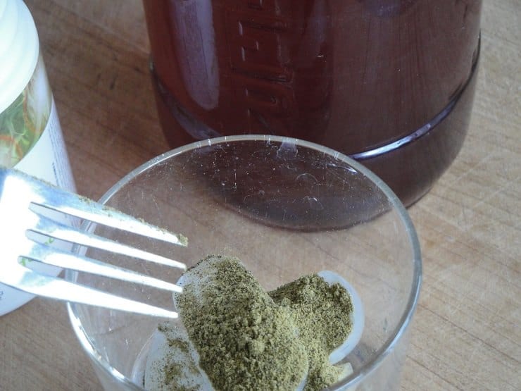 eye up a teaspoon of probiotic powder in the glass