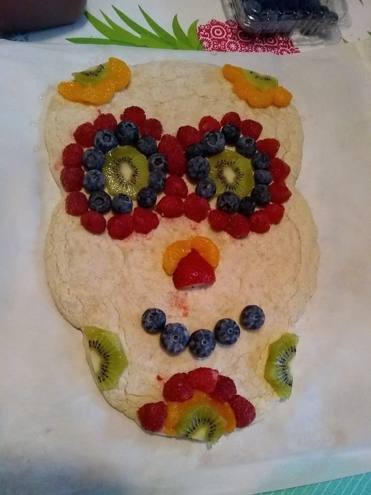 Fruit pizza with skeleton head shaped crust