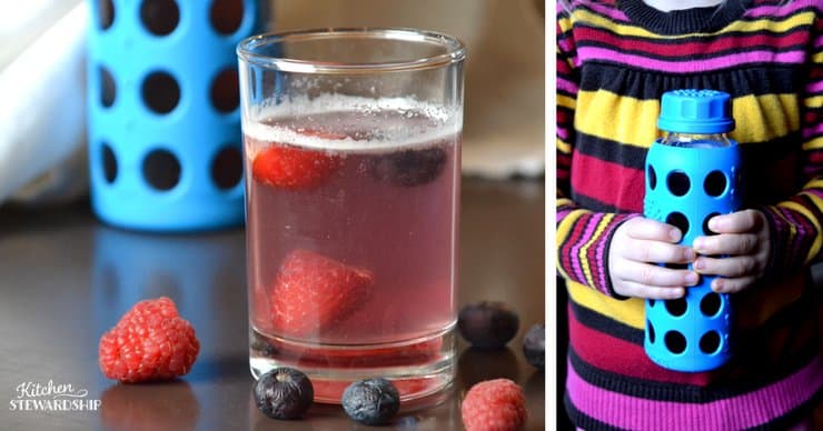 Glass of homemade smart water with strawberries, blueberries and raspberries in it. Picture next to it is of a young girl holding a lifefactory glass water bottle.