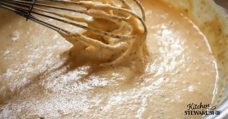 Bowl of gluten free pizza dough looks more like cake batter then pizza dough.