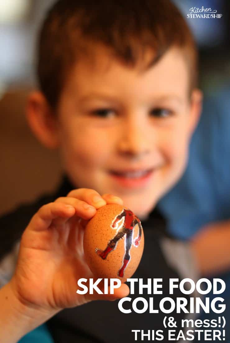 Young boy holding up an Easter egg decorated with a temporary tattoo.