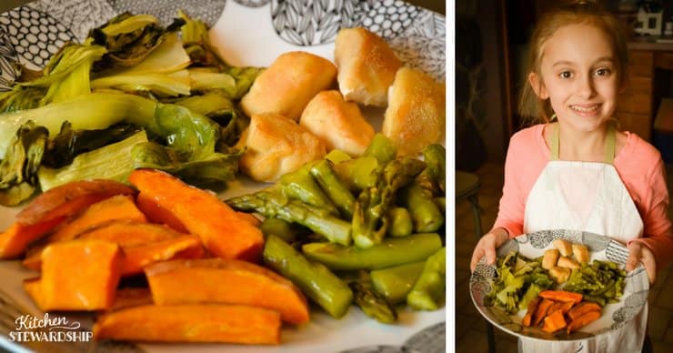 Young girl holding plate with chicken, roasted asparagus, roasted sweet potatoes and bok choy.