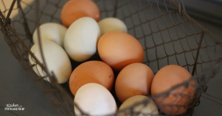 Farm fresh eggs in a metal basket.