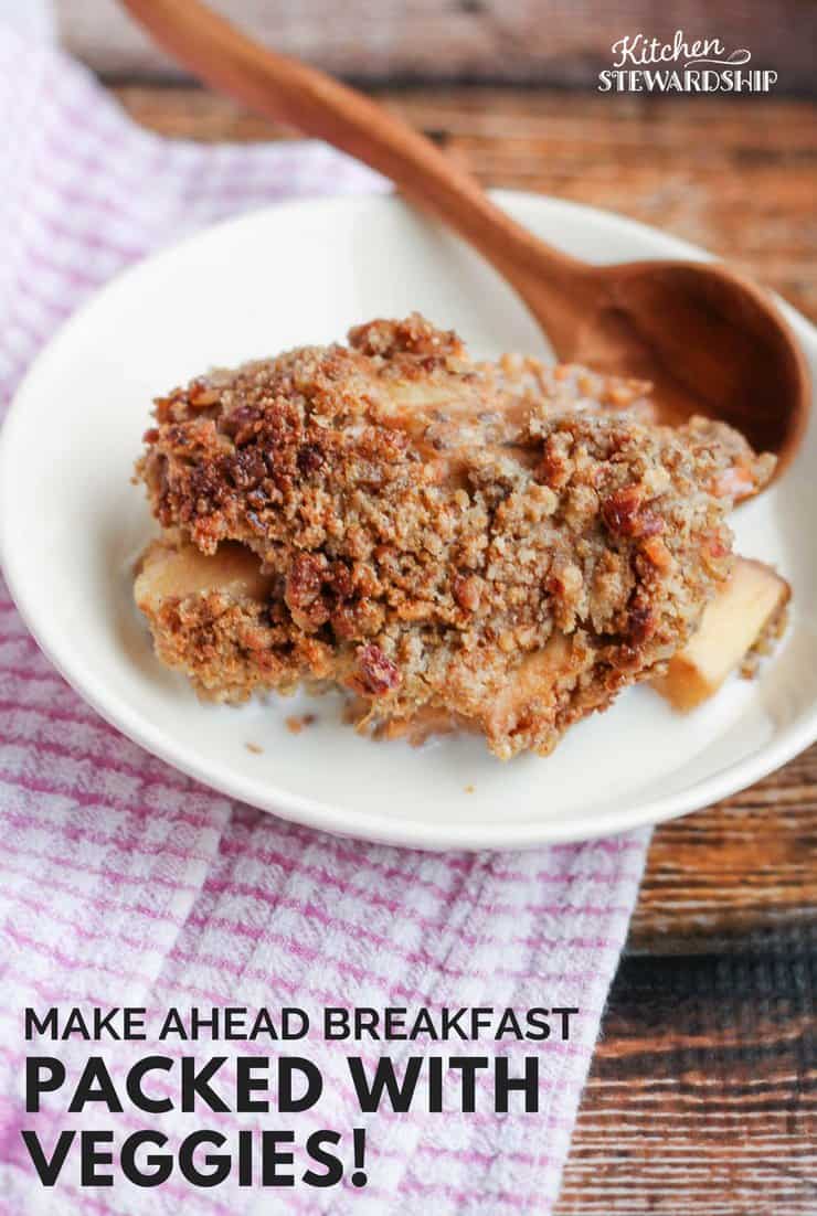 Sweet potato breakfast bake in a white bowl with milk and a wooden spoon on a wood table with pink and white checked napkin. Words say: Make ahead breakfast packed with veggies!