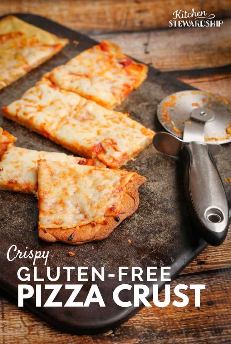Cut up crispy gluten-free cheese pizza on a pizza stone.