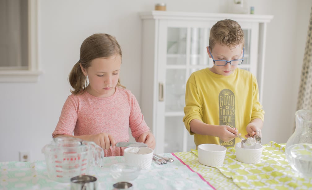 kids measuring flour flat for baking