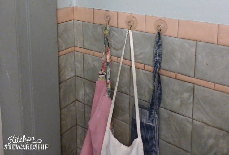 Using hooks in the bathroom to add more space. 