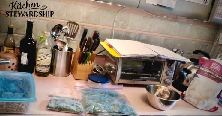 Using the top of a countertop appliance to add more counter space while cooking. 