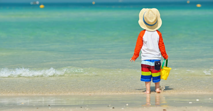 toddler on the beach in hat