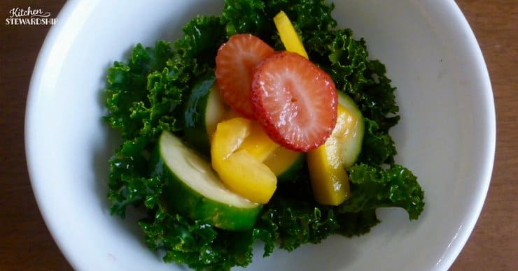 kale salad with strawberries, mango and cucumber