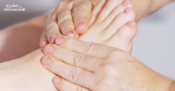Mom massaging child's foot to relieve growing pains. 