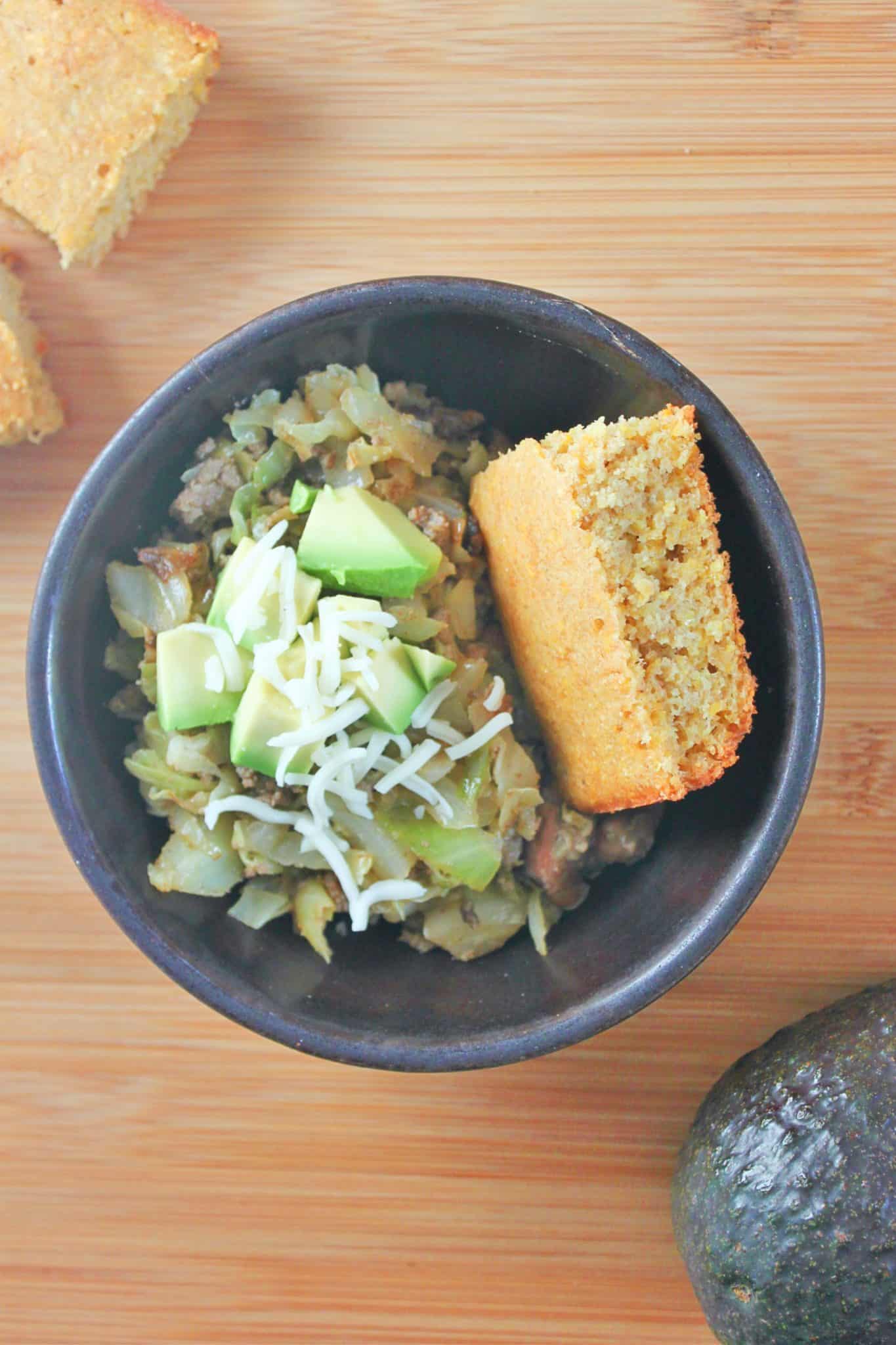 Bowl of homemade cumin beans with homemade cornbread