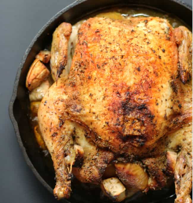 whole roasted chicken in a cast iron skillet