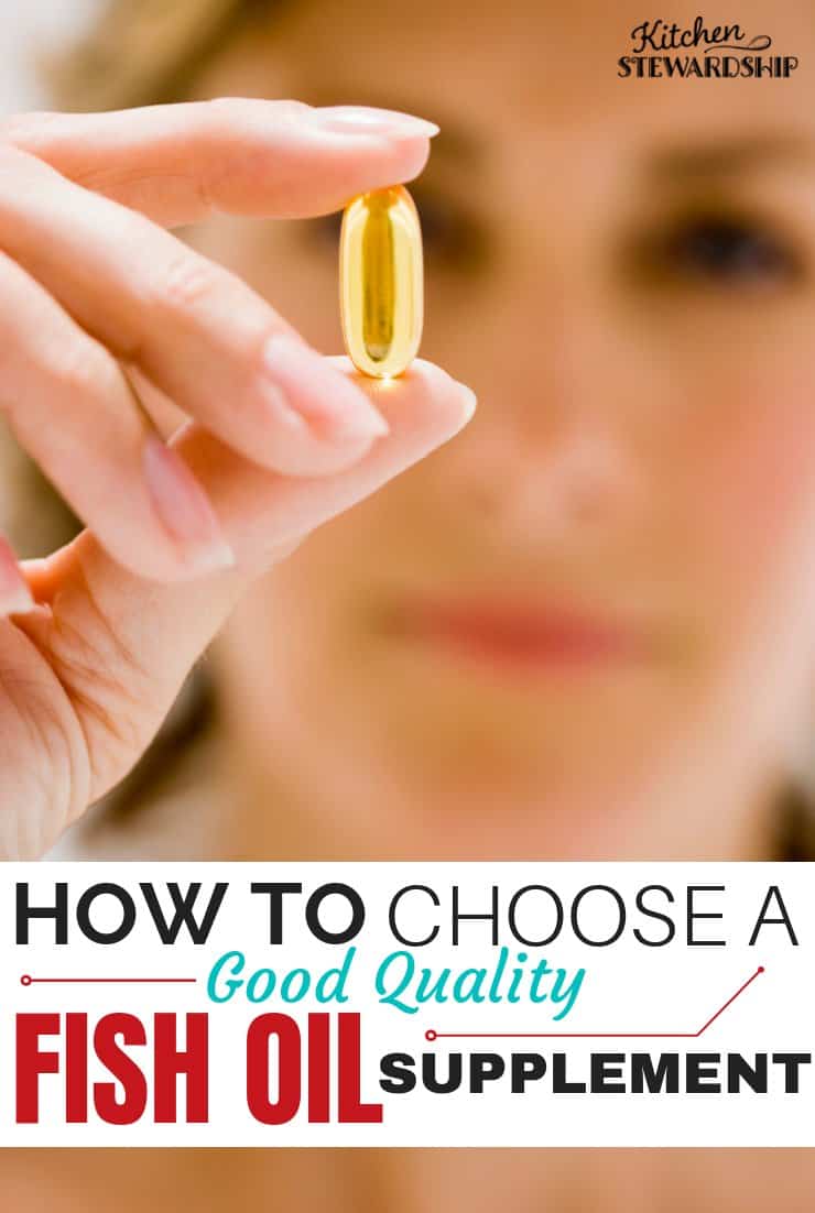 Holding a fish oil pill.