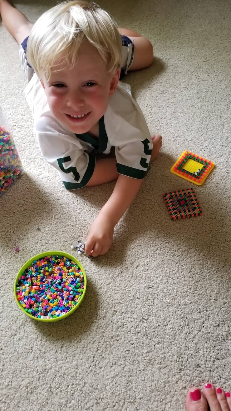 boy playing with beads