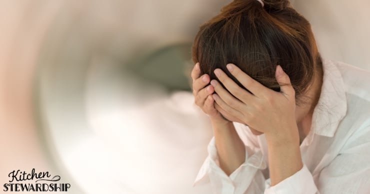 Woman holding head concussion