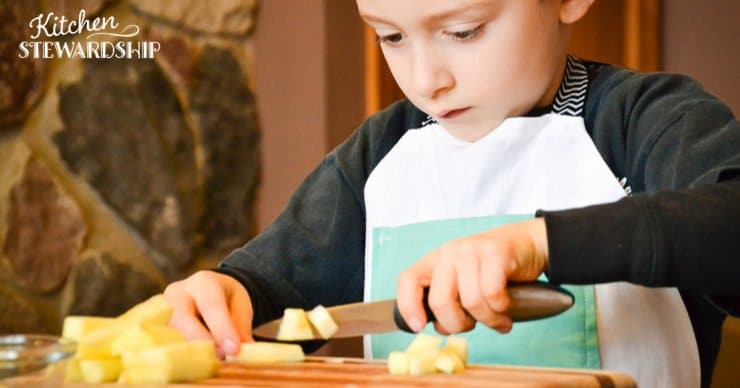 boy cutting apples