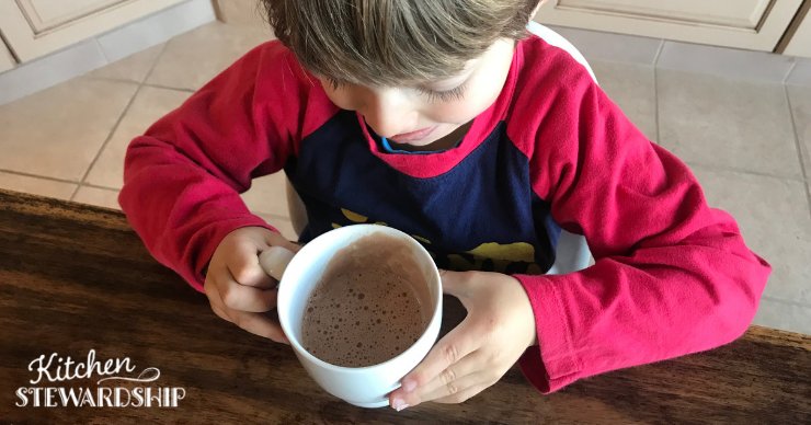 Boy drinking hot cocoa with collagen