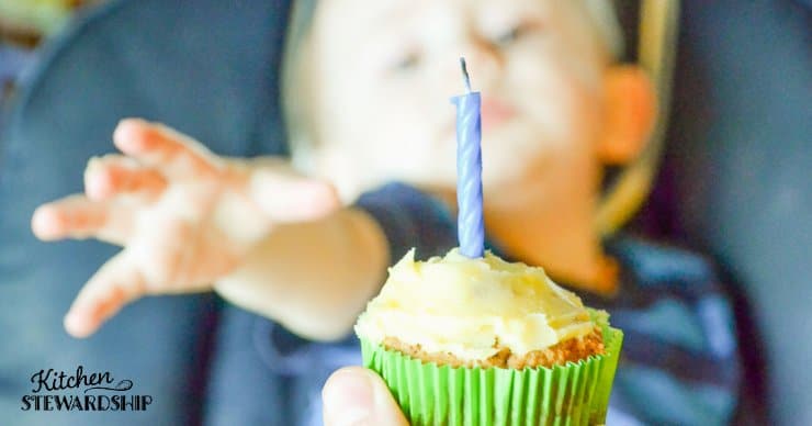boy reaching for cupcake